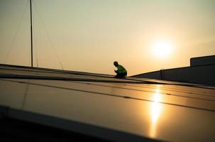Technicians provide quarterly solar cell maintenance services on the factory roof photo