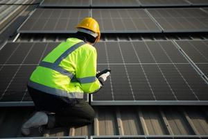 Technicians provide quarterly solar cell maintenance services on the factory roof photo