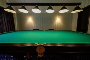 Billiard table in the hotel, sports game for relaxation. photo