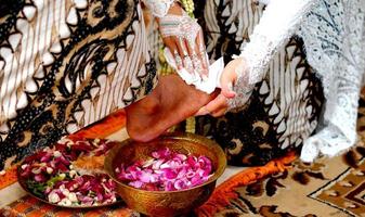 Wedding Tradition in Indonesia the Bride Washes the Groom's Feet photo