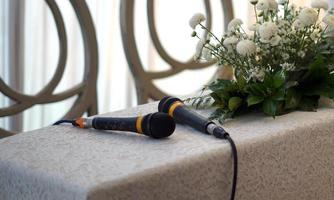 Two Microphones and Flowers on a Table for Wedding Procession photo