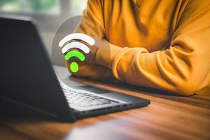 hombre usando una computadora portátil para conectarse a wifi pero la señal wifi es muy débil, y esperando cargar el sitio web del formulario de datos comerciales digitales, concepto de espera para conectarse a wifi. foto