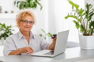 an elderly woman shopping online photo