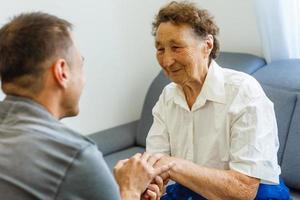 Grandson visiting grandmother at home in quarantine photo