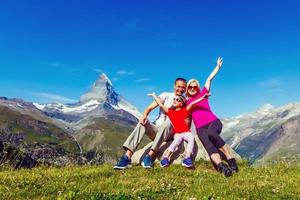 Active family hiking in high alpine region in alps photo