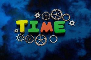 Time wording with gears as time concept photo