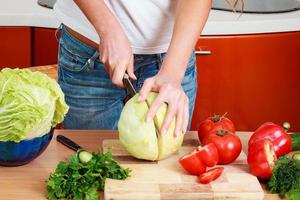 Closeup shot of a woman preparing a salad photo