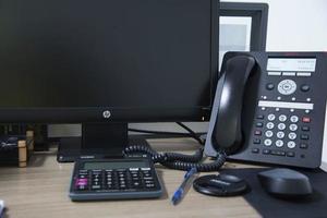 office desk stuff with phone mouse and keyboard photo