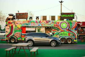 range rover car in front of colorful kiosk photo