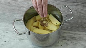 Raw peeled potatoes in a pot of water before cooking video