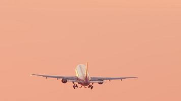 Jet passenger airplane departure at sunset. Picturesque sunset and flying away airliner. Tourism and travel concept, modern aviation video