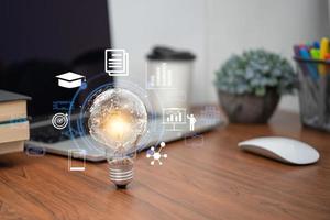 Bright lightbulb glowing with learning icons for study knowledge to creative thinking idea. Business success idea of learning, planning or working. Education solution or training skill concept. photo