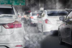 Smoke pollution from car exhaust pipes, traffic jams on the roads at rush hour. photo