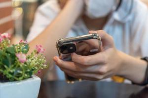 teenage girl using mobile phone on hand. photo