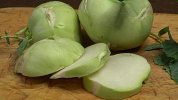 Fresh kohlrabi Brassica oleracea Gongylodes on a wooden cutting board video