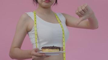 Beauty slim female confuse high calorie food. Women disgust food that makes fat, weight lose, balance, control, reduce fat, low calories, routines, exercise, Diet, reduce sugar intake, excess fat video