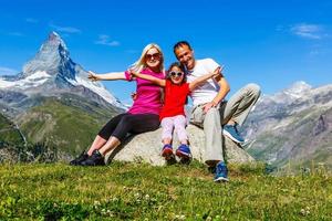 Family on a trek day in the mountain looking at the view photo