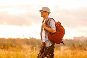 Backpacker Girl Looking at Sunset photo