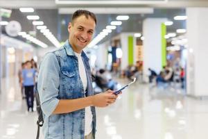 Young man with backpack in airport in terminal photo