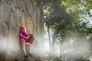 stylish hipster woman with backpack looking at amazing woods and mountains in summer, travel concept, space for text photo