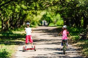 Little boy riding electrical scooter photo