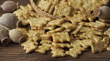 Baked party poppy seed crackers, dry poppy heads . Salty snacks video