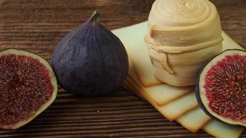 Figs, various cheese on a rustic table.Traditional hand made slovak smoked cheese parenica. Healthy eating concept. video