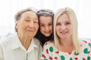 Senior knitting with her granddaughter at home photo