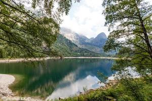 alpine high mountain lake, coniferous woods are reflected in the water, Antrona valley Campliccioli lake, Italy Piedmont photo