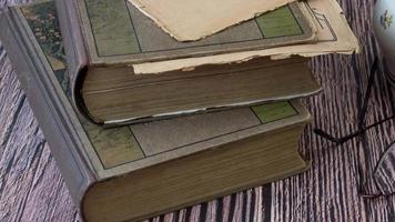 Stack of books with glasses and cup of tea. video