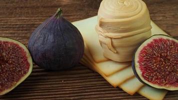 Figs, various cheese on a rustic table.Traditional hand made slovak smoked cheese parenica. Healthy eating concept. video