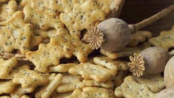 Baked party poppy seed crackers, dry poppy heads . Salty snacks video