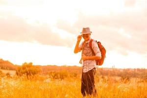 alejándose de todo. hombre en campo abierto relajante mirando la hermosa vista. foto