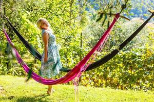 Hammock out on sunny yard near flower garden photo