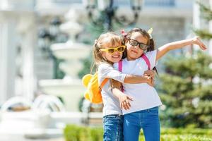 Happy children girls girlfriend schoolgirl student elementary school photo