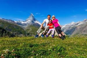 Family on a trek day in the mountain looking at the view photo