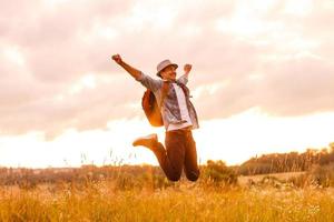 Getting away from it all. Man in open field relaxing looking at the beautiful view. photo