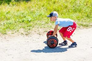 Little boy riding electrical scooter photo