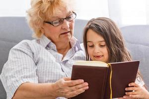 grandmother and granddaughter read photo