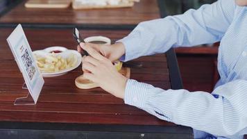 Woman use smartphone to scan QR code to pay in cafe restaurant with a digital payment without cash. Choose menu and order accumulate discount. E wallet, technology, pay online, credit card, bank app video