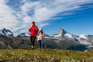 Traveler in the Alpine meadow, Switzerland photo