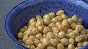 Cooked chickpeas Cicer arietinum in bowl on black background video