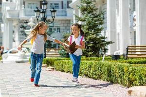 Happy children girls girlfriend schoolgirl student elementary school photo