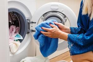 Housework young woman doing laundry photo