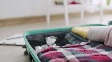 suitcase full of clothes for a weekend trip to the temple. Preparation before traveling after the opening of the country.Exceeding the new normal tourism concept video