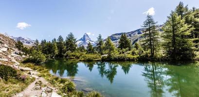 Amazing view of touristic trail near the Matterhorn in the Swiss Alps. photo