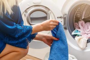 Laundry in washing machine and basket indoors photo