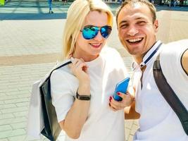 Loving cheerful happy couple taking selfie in the city. photo