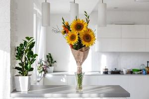 Jar covered in burlap and lace filled with faux sunflowers photo