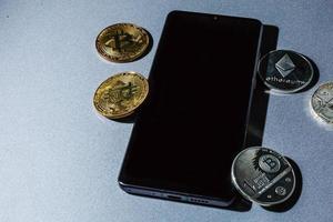 bitcoin to phone. bitcoin and shiny gold bars photo